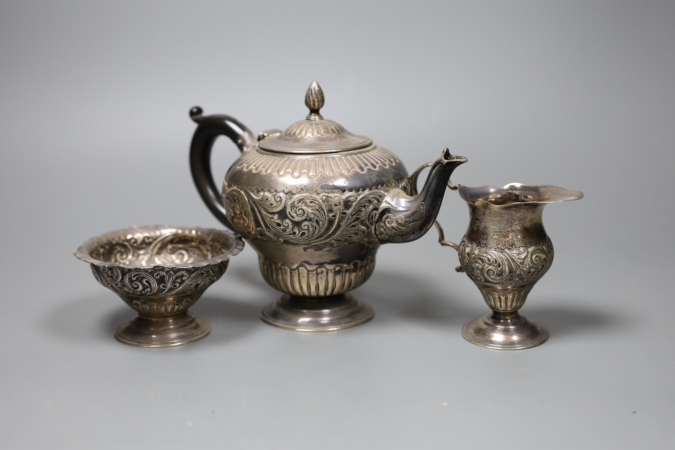 A Victorian three piece silver bachelor's teaset, London 1883, gross 14.5 oz.